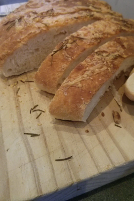 some bread on a  board with a spoon