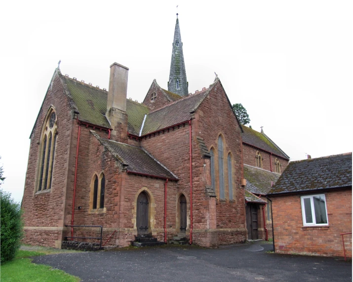 a brick church with an ornate roof and steeple