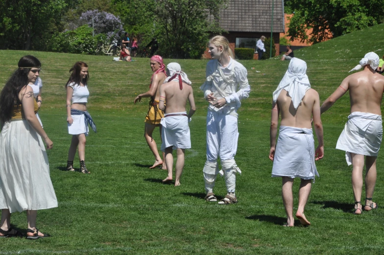 a group of people with costumes are outside