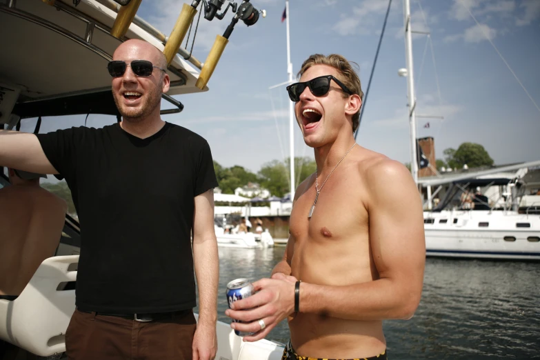 two men on a boat with one shirt off and one without