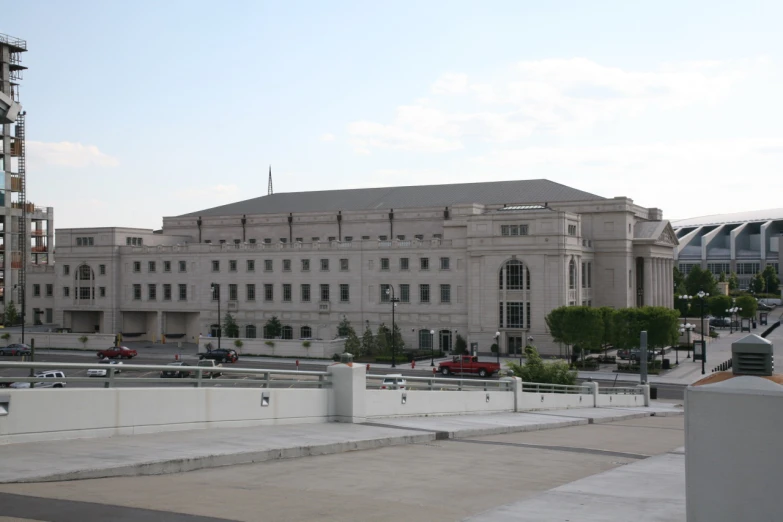 cars parked in front of a large white building