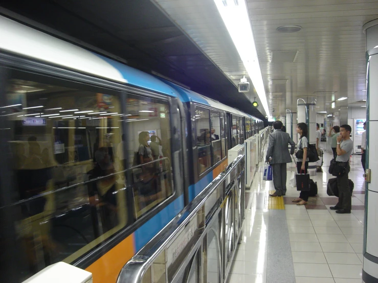 a group of people waiting for a subway