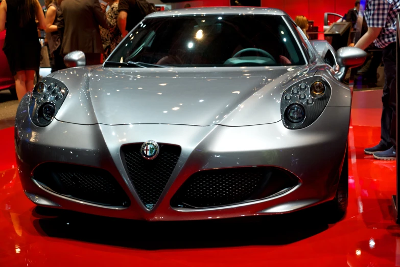 an automobile sitting on top of a red surface