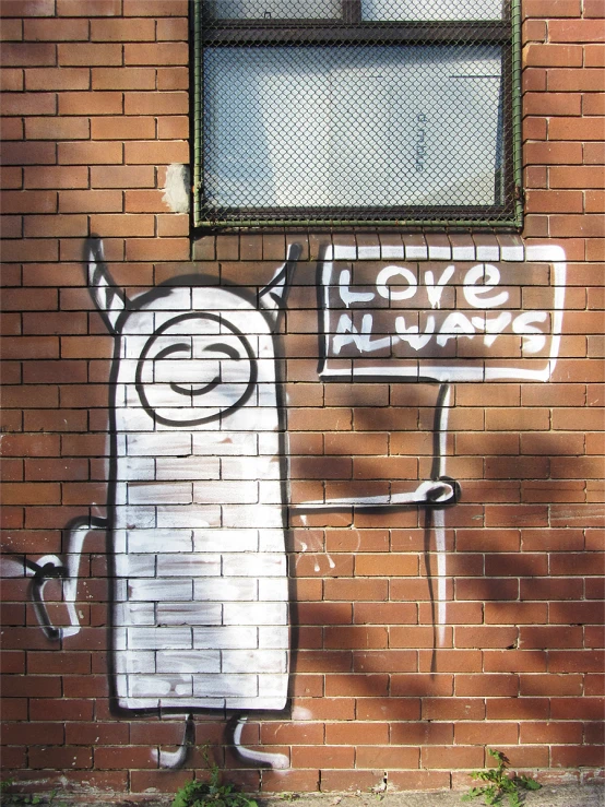 a white sign on a brick wall by a window