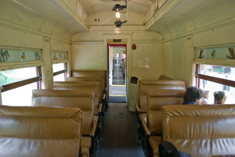 a bunch of seats in an old looking train