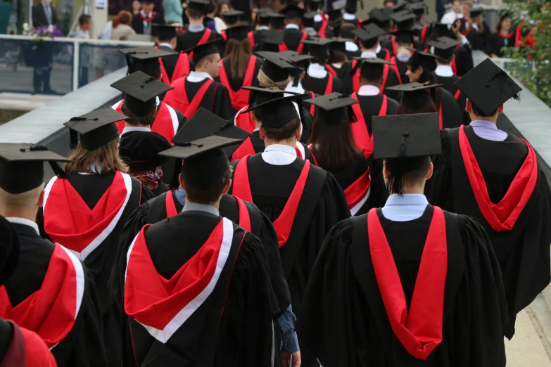 group of graduates in gowns and caps at graduation