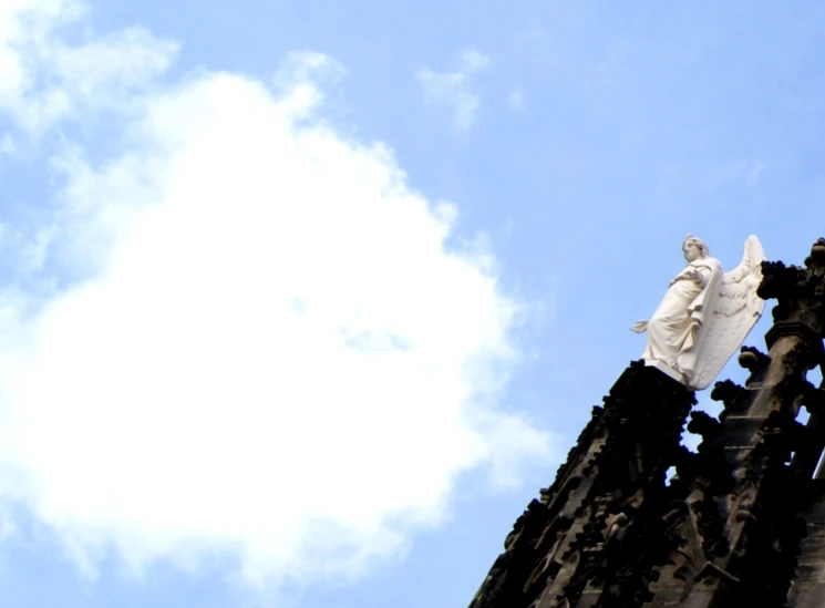 the statue on the building has angels painted all over it