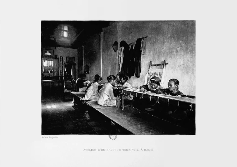 black and white pograph of school girls at a desk