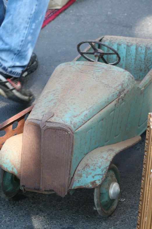 a car made out of old wheels on the ground