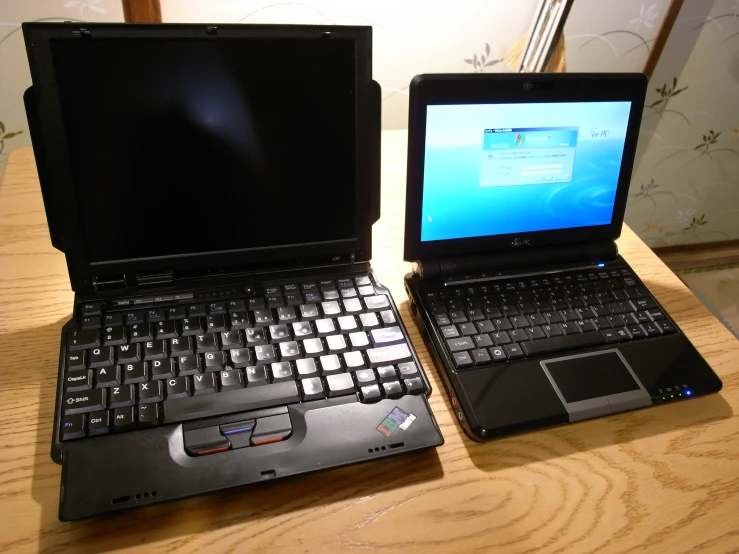 two laptops with one being a lap top and the other is a larger computer