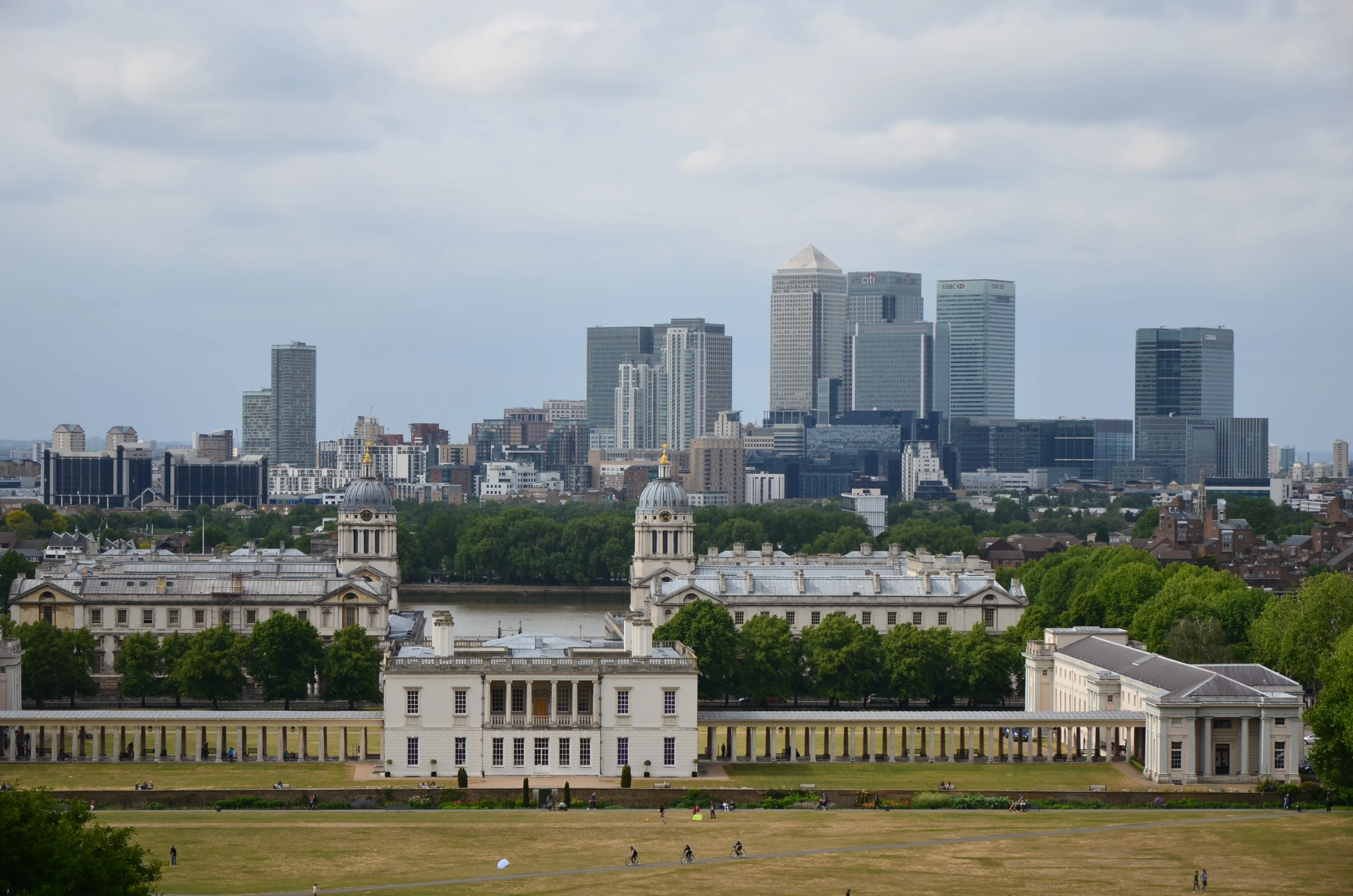 the city skylines behind a grassy field and some trees