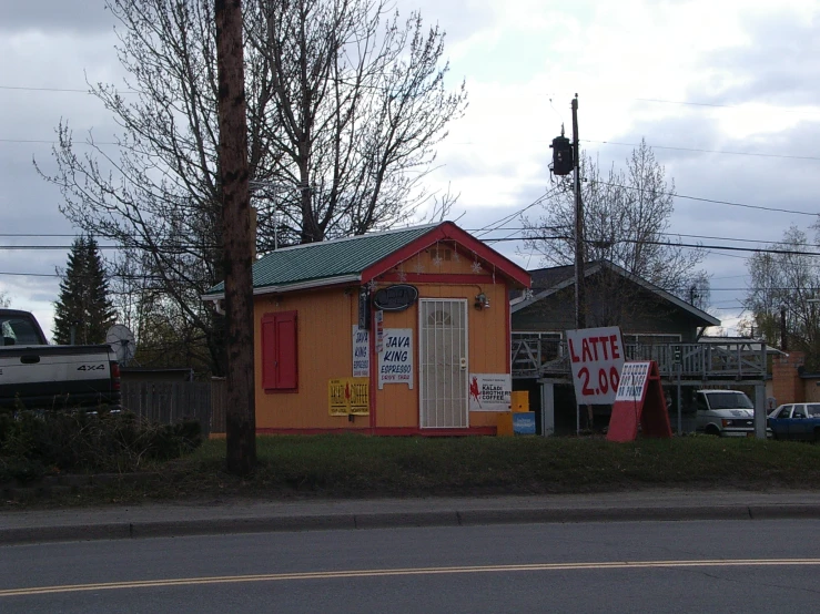 a small building with lots of stickers hanging on the outside