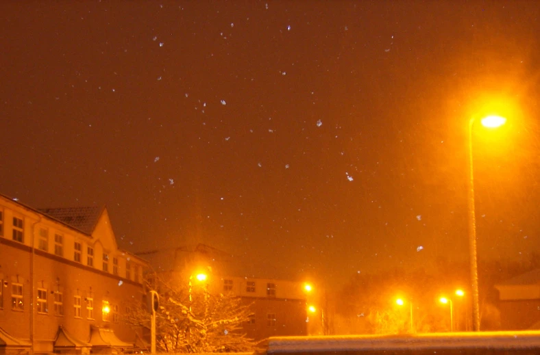 night sky in a residential area with lights on