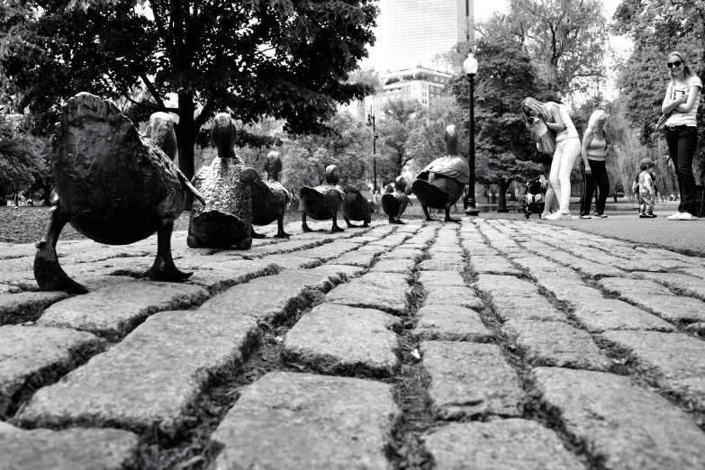 group of people walking around a cobble stone path