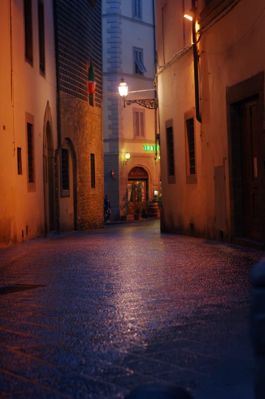 an empty courtyard in an old town at night