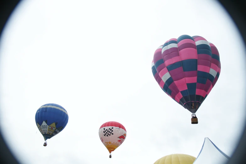 three different balloons are flying through the air