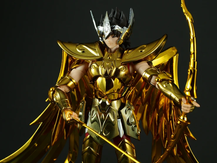 a person wearing gold armor holding a sword and gold armor