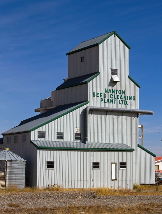 a grain factory building with a sign reading bedding seed bank and plant ltd