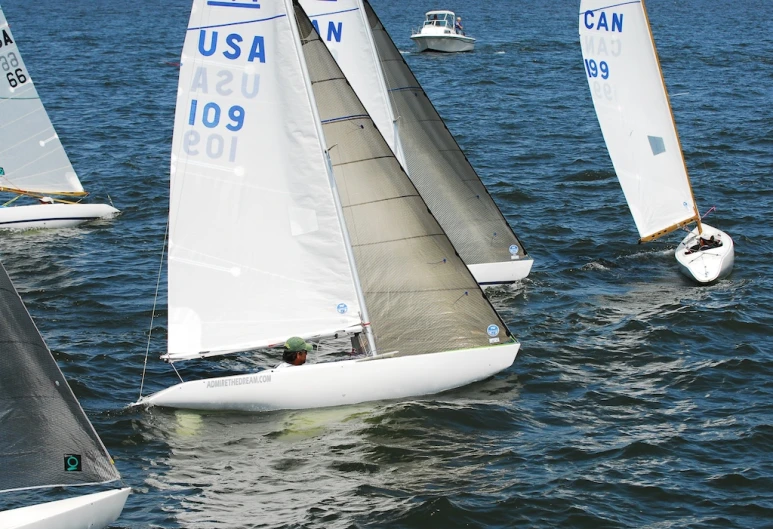 three small boats sailing in the open water