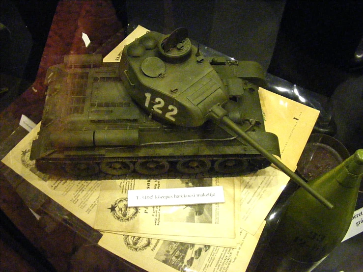 a picture of a tank on a desk next to a newspaper