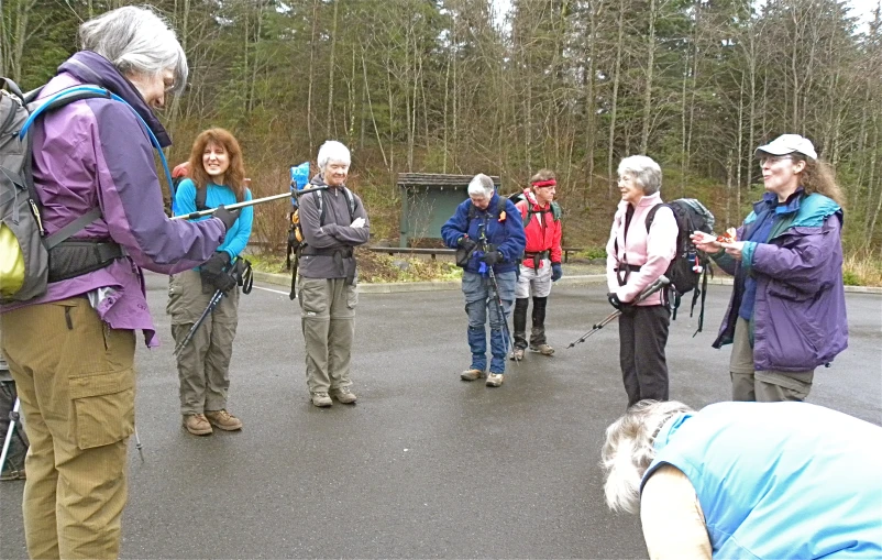 people gathered in the street with a white dog