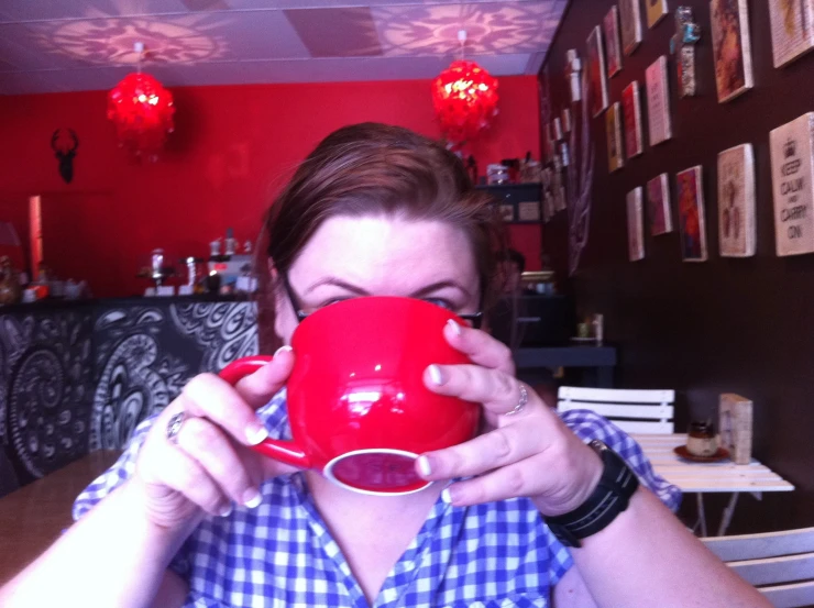 a woman in the midst of taking a coffee cup