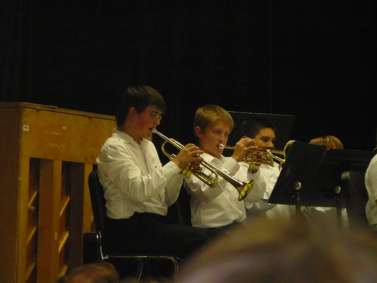 a group of people standing around playing musical instruments