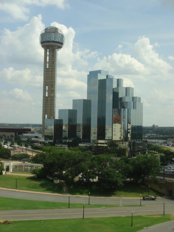 buildings next to a tower with a television atop