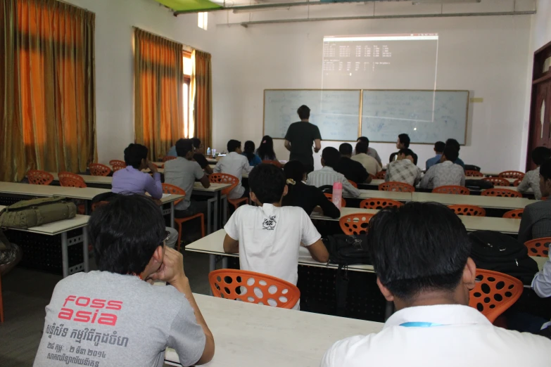 a classroom full of people sitting at their desks