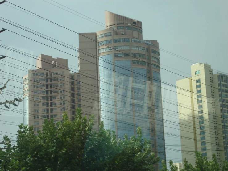 the high rise buildings are beside electric wires