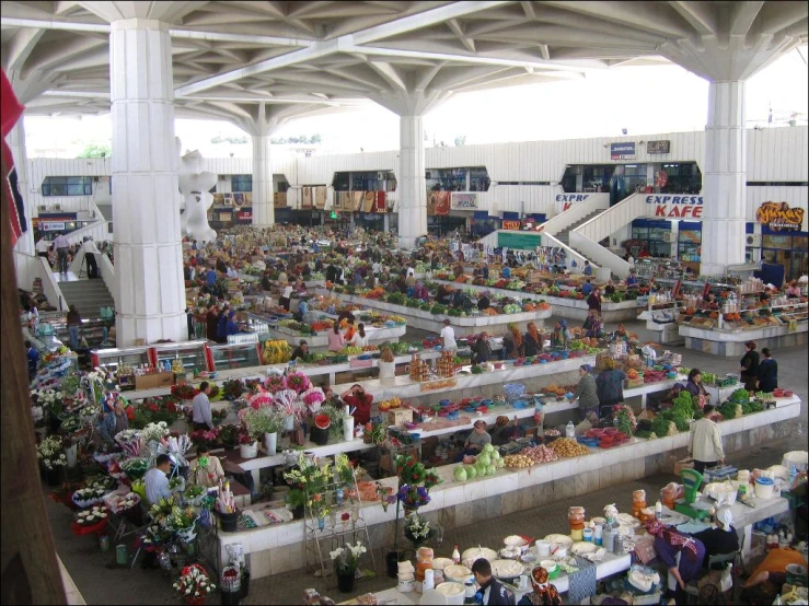 this is an indoor market with people looking at items