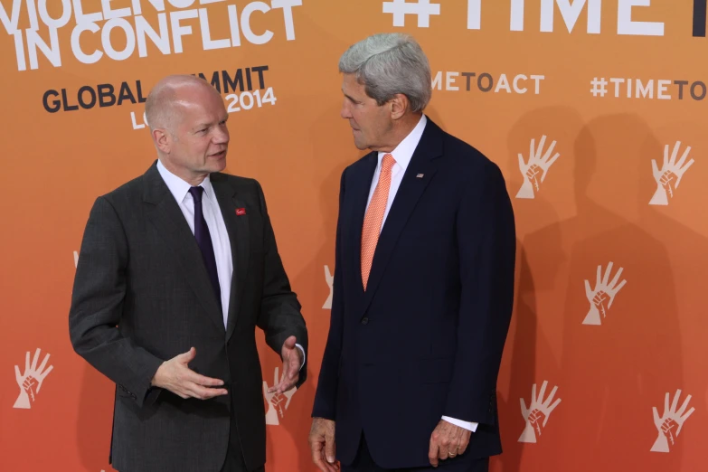 two men in suits talking to each other