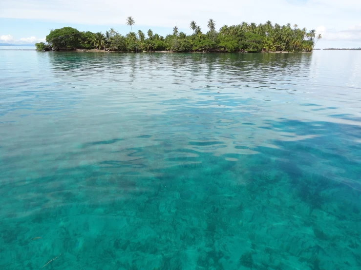 a small island is in the middle of a lagoon