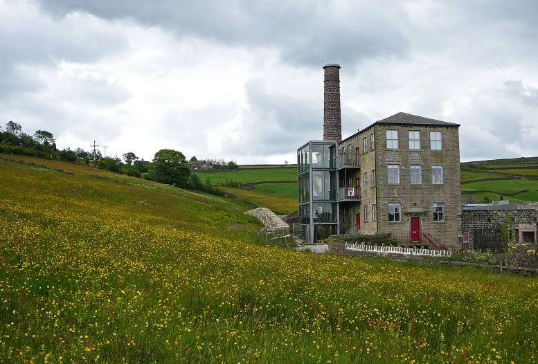 an old abandoned building on a hill side