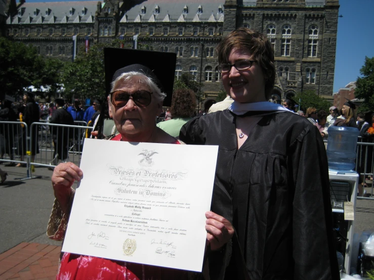 there are people in costume holding up a diploma