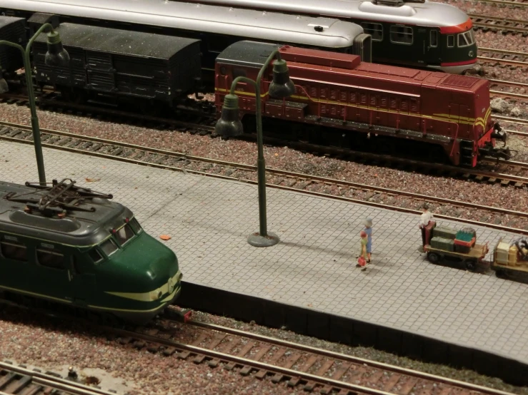 some miniature trains that are on a set of tracks