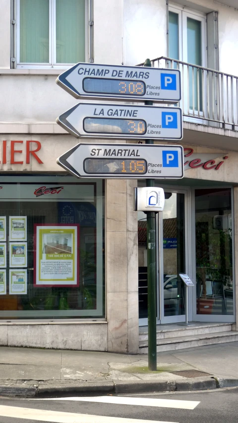 a street corner with several signs attached to the side