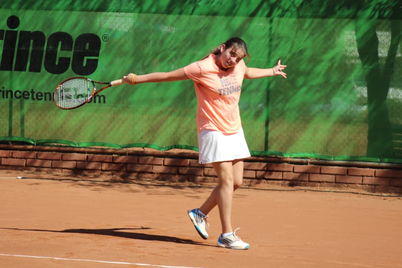 a tennis player is swinging his racket to hit a ball