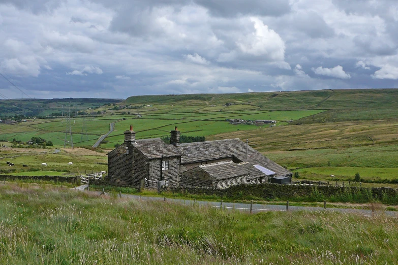 the old stone building is perched on the hillside