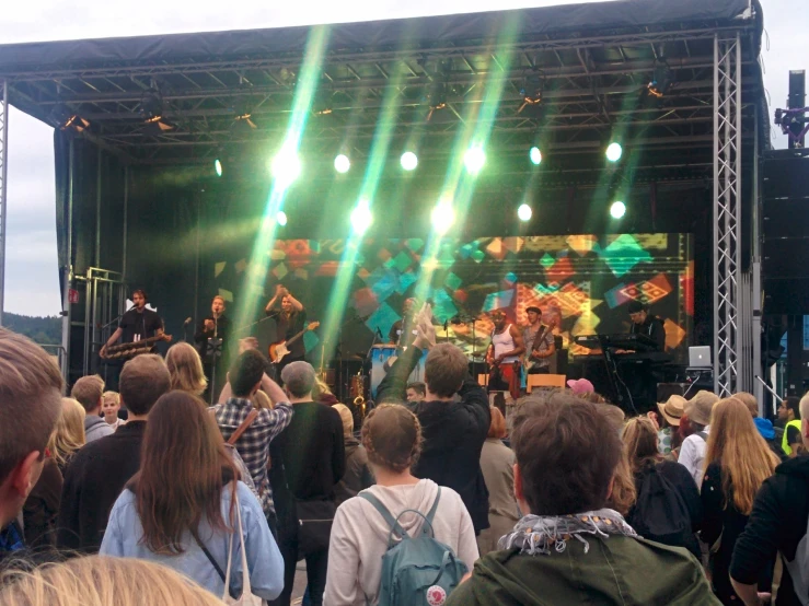 a large crowd of people standing on top of a stage