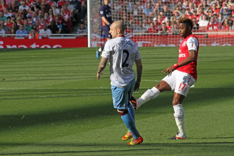 two soccer players facing each other on a field