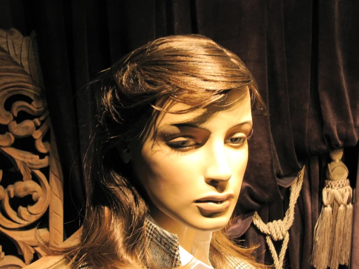 a very pretty dressy female mannequin wearing a head piece