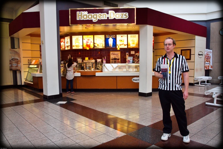 the young man is standing outside of a store