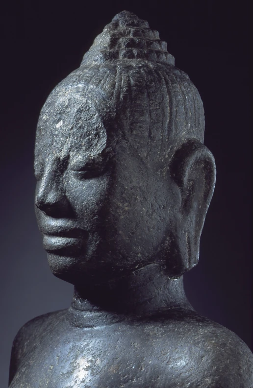 a black statue of a buddha in profile