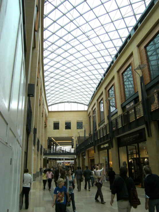 people walk through an area with two skylights