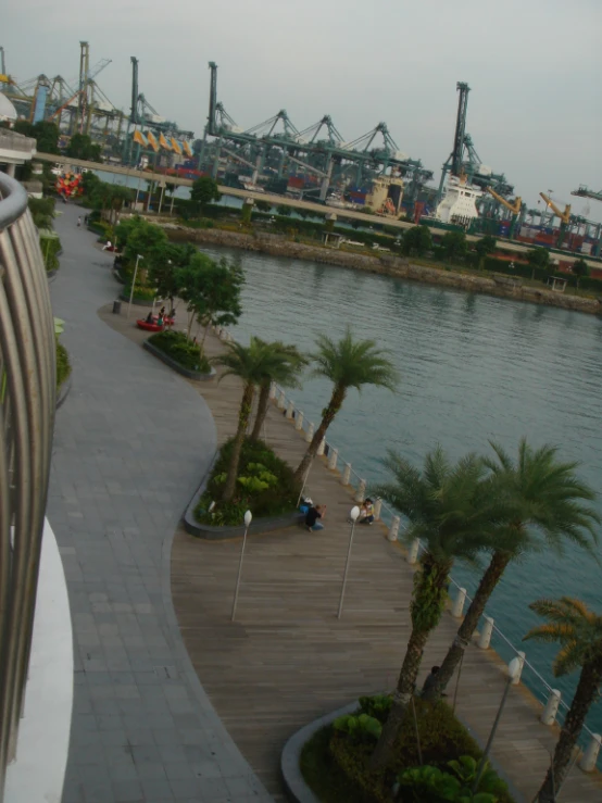 a pier near a body of water with boats and buildings