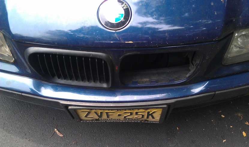 the front end of a blue bmw car