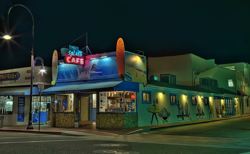 a restaurant with a neon sign is on the street