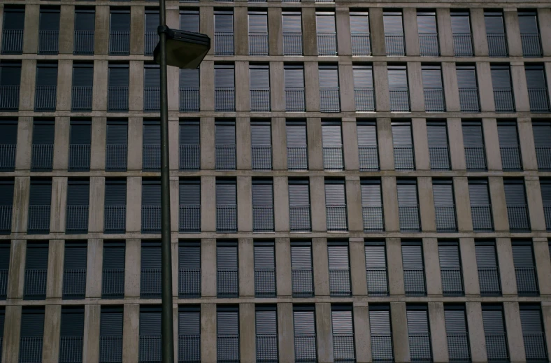 a street light sitting in front of a tall building