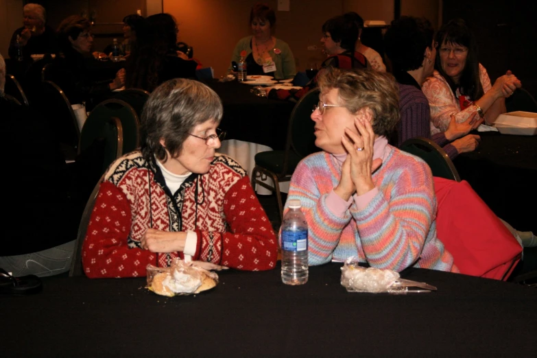 an old woman is having her hand on a younger woman's face